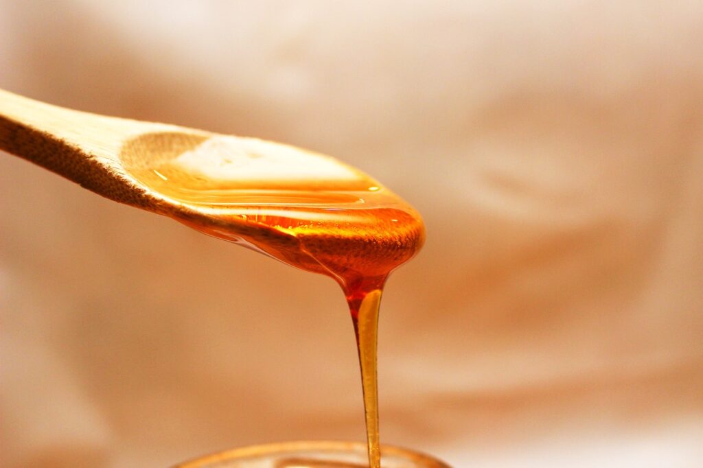 Honey flowing off a spoon