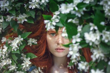 sustainable beauty woman with red hair in nature